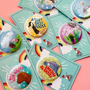 group of colourful handmade pin bags and magnets with animal designs