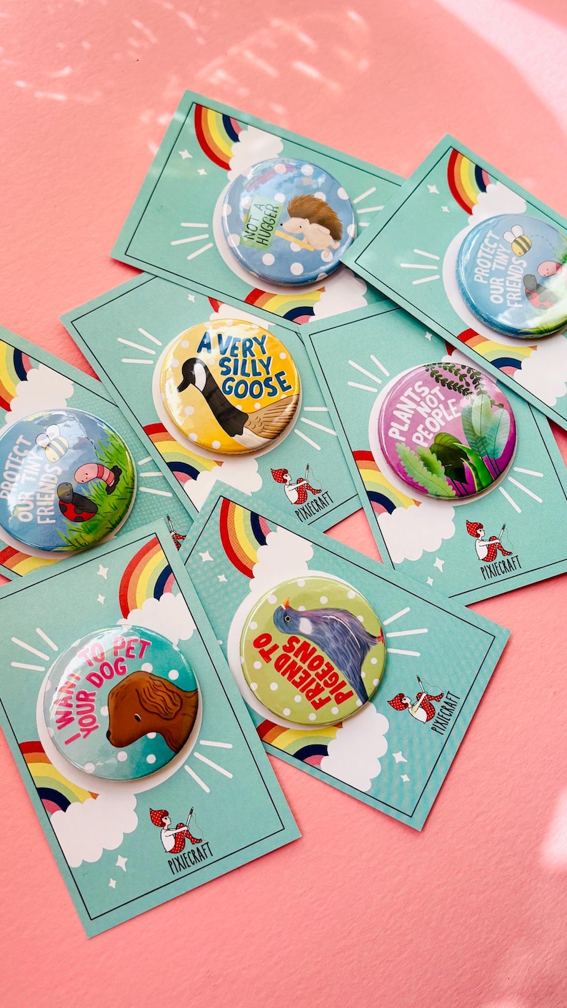 group of colourful handmade pin bags and magnets with animal designs