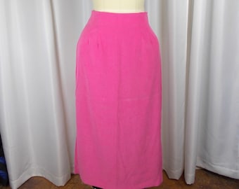May include: A long pink skirt on a dress form. The skirt is a simple, straight cut with a high waist.
