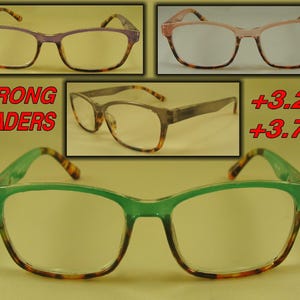 May include: A set of three pairs of reading glasses with tortoise shell frames. The glasses have different colored frames: purple, pink, and green. The text "STRONG READERS" and the numbers "+3.25" and "+3.75" are visible in the image.