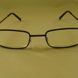 May include: Black rectangular eyeglasses with a thin metal frame.