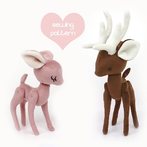 May include: Sewing pattern for two plush deer toys. One deer is brown with white antlers and ears. The other deer is pink with white ears. The pattern is titled "sewing pattern".