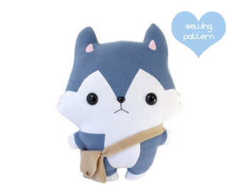 May include: A blue and white plush toy wolf with a brown strap and a small brown bag. The toy has a cute, cartoonish face with black eyes and a pink nose.