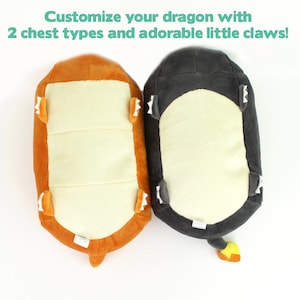 May include: Two plush dragon toys, one orange and one gray, with different chest designs. Both have small white claws on their feet.