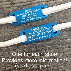 May include: Two blue shoe tags with white laces. The top tag reads "Jayden AUTISTIC/NON VERBAL Won't respond May resist help (more info-other shoe)". The bottom tag reads "PLEASE CALL: Steve: 555-333-7777 Margie: 333-555-8888 (more info-other shoe)". The text below the tags reads "One for each shoe Provides more information! (sold as a pair!)"