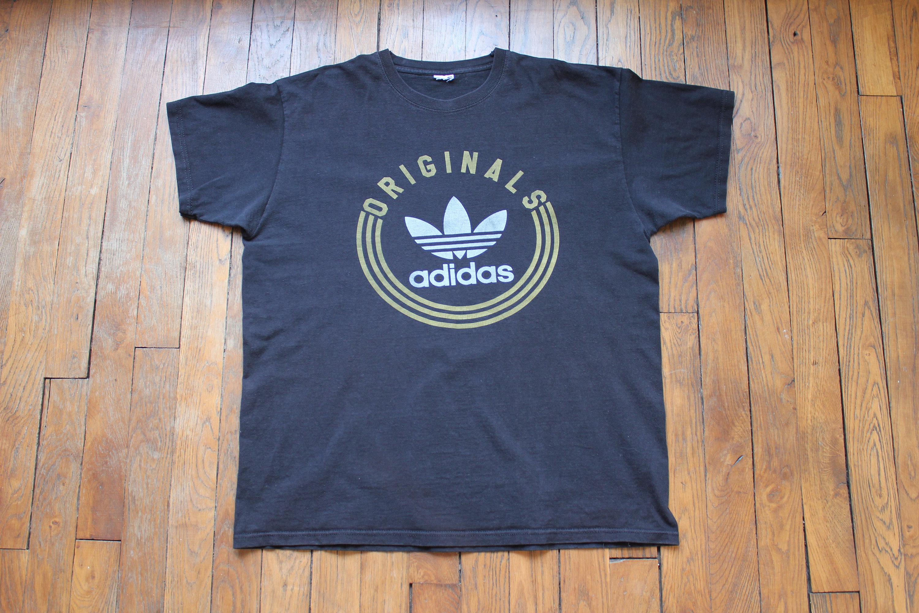 white adidas t shirt with gold logo