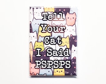 May include: A rectangular magnet with a design of cartoon cats in various colours. The magnet displays the text "Tell Your Cat I Said PSPSPS" in white, ideal for cat owners.