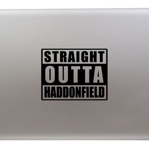 May include: A silver laptop with a black sticker that says "STRAIGHT OUTTA HADDONFIELD".