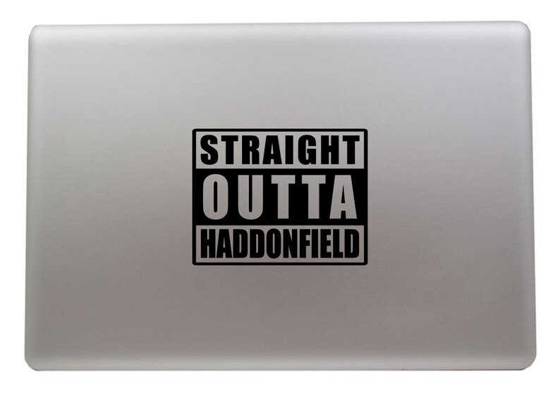 May include: A silver laptop with a black sticker that says "STRAIGHT OUTTA HADDONFIELD".