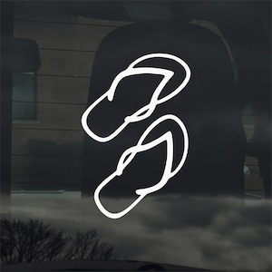 May include: White outline of a pair of flip-flops, a summer footwear staple. The design is simple and clean, perfect for a car window decal or sticker. The image is set against a dark background.