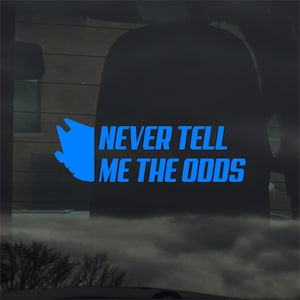 Puede incluir: Calcomanía azul con el texto "NEVER TELL ME THE ODDS" y un gráfico estilizado de una nave espacial. El texto está en negrita, sin serifa. Diseñado para ser aplicado en una ventana de coche o superficie similar.