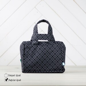 May include: A black and gray patterned tote bag with a single handle. The bag is labeled "Regular Quad".