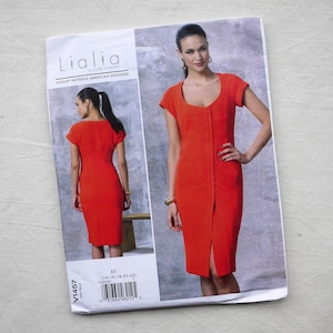May include: A sewing pattern for a red dress with a front slit. The pattern is from Lialia by Judith Aaron, Vogue Patterns American Designer, and is size 14-16-18-20-22. The pattern number is V1457.