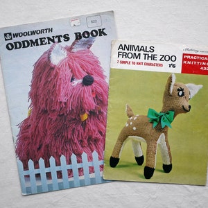 May include: Two knitting pattern books. The first book is titled "Woolworth Oddments Book" and features a pink knitted dog. The second book is titled "Animals From The Zoo" and features a brown and white knitted deer with a green bow.