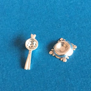 Miniature silver tea strainer and stand