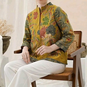 May include: A yellow and green floral patterned jacket with a mandarin collar and long sleeves. The jacket is made of a soft, lightweight fabric and has a relaxed fit.