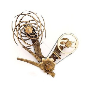 May include: A wooden kinetic sculpture with a spiral design and a belt-driven gear system. The sculpture is made of light brown wood and has a gold finish.