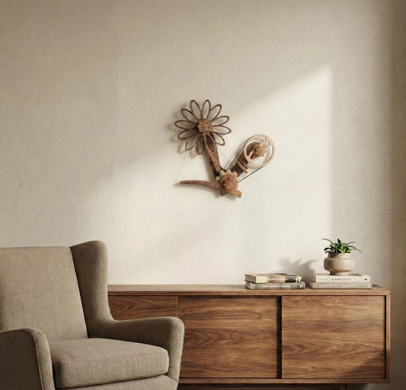 A handcrafted kinetic daisy wall clock where the petals actually move to tell time — a living sculpture that replaces your boring wall clock.