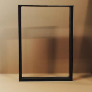 May include: Black metal table legs with a rectangular frame.
