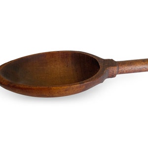 May include: A large, wooden spoon with a long handle. The spoon is made of dark brown wood and has a smooth, rounded bowl.