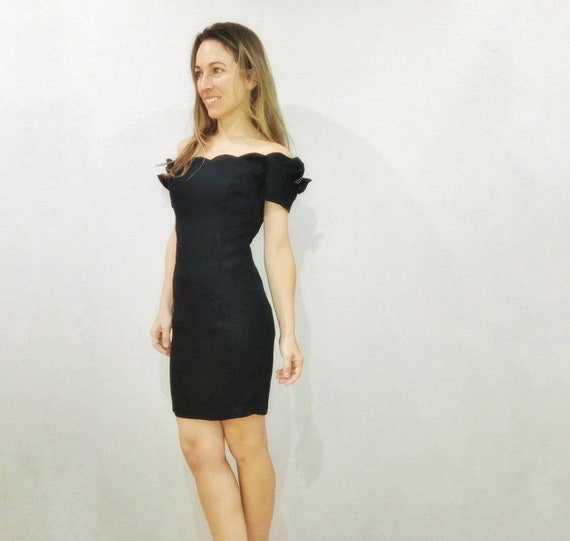 black dress with scalloped neckline