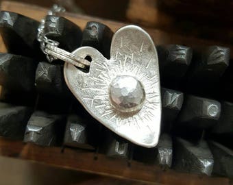 Necklace with silver heart that is curved with a pebble burst centre. Handstamped on the back. Unique jewellery perfect gift for a loved one