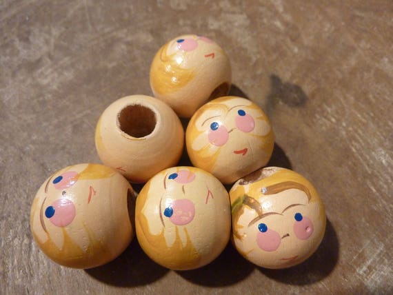 wooden doll heads with faces