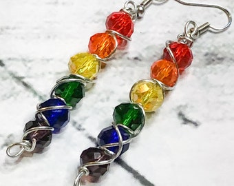 May include: Rainbow coloured crystal bead earrings with silver wire wrapping and silver hooks.