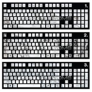 May include: Three black keyboard layouts with white marble-patterned keycaps. The layouts are labeled 1, 2, and 3. The keycaps are arranged in a standard keyboard layout with keys for letters, numbers, punctuation, and function keys.