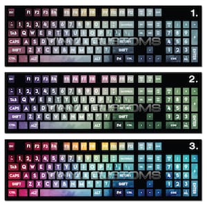 May include: Three watercolor keyboard designs with a black background. The first keyboard is a mix of pink, purple, and blue. The second keyboard is a mix of green and blue. The third keyboard is a mix of blue, green, and yellow.