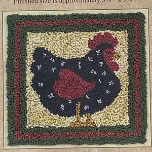 May include: Punchneedle embroidery kit featuring a black hen with red accents. The finished size is 3 3/8 inches by 3 3/8 inches. The kit includes a transfer, yarn, and needle.