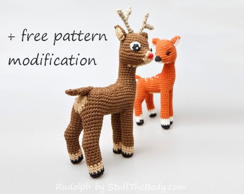 May include: Two crocheted deer, one brown and one orange, standing side-by-side. The brown deer has a red nose and large eyes. The text "+ free pattern modification" is visible at the top of the image.