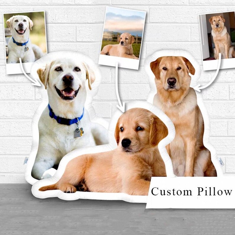 May include: Custom dog-shaped pillow featuring a smiling white Labrador, a golden puppy, and a seated golden Labrador. The design includes three small photo prints of dogs. The text "Custom Pillow" is at the bottom.