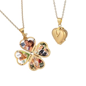 May include: Two gold-colored necklaces with pendants. One pendant is a heart-shaped locket. The other is a four-leaf clover locket, each leaf holding a photograph. The photos show people and pets.