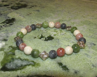May include: A bracelet with green, white, and pink beads and silver Celtic knot charms.