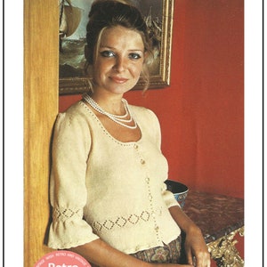 May include: A woman wearing a cream knitted cardigan with a button-up front and a diamond-shaped lace pattern. She is standing next to a wooden door frame and has a pearl necklace on. The image has a pink circle with the text "A My Vintage Wish Retro and Vintage Pattern Retro Knitting" in white.