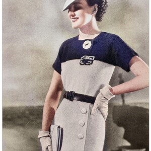 May include: A vintage knitting pattern for a white and navy blue dress with short sleeves. The pattern is designed to fit a 34 inch bust. The pattern is from "My Vintage Wish Patterns" and is labeled "Retro Knitting".