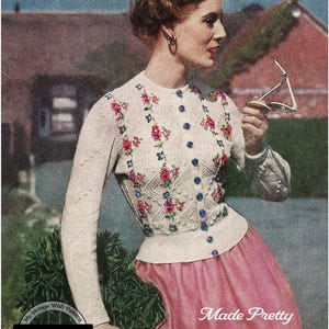 May include: A white knitted cardigan with a floral embroidery design. The cardigan has a button closure and is made with 3-ply yarn. The text "Designed to fit a 32-33 or 34-35 inch Bust" and "3 ply" are visible at the top of the image. The text "My Vintage Wish Patterns" and "RETRO KNITTING" are visible in a circle at the bottom left of the image. The text "Made Pretty with Hand Embroidery" is visible at the bottom right of the image.