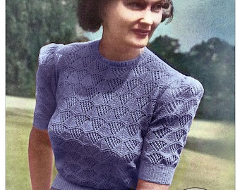 May include: A vintage knitting pattern for a short-sleeved, periwinkle blue sweater with a textured, repeating wave-like stitch pattern. The text reads 162 PATONS BEEHIVE FINGERING, 2-PLY, Patonised shrink-resist finish, RETRO KNITTING, and Designed to fit a 38 Bust.