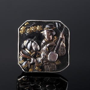 An antique brooch pin which depicts two Japanese Geisha girls in the Shakudo technique. This panel was made in the Meiji period by the Samurai makers of Samurai armour.