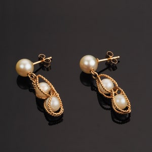 Vintage gold pearl earrings with a round pearl on gold post and drop dangle two pearls held within a ropetwist basket of gold.  Pearls are a beautiful oyster.
