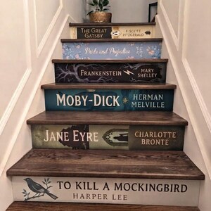 May include: A staircase with risers decorated to resemble book spines, featuring titles including The Great Gatsby, Pride and Prejudice, Frankenstein, Moby-Dick, Jane Eyre, and To Kill a Mockingbird, with a small potted plant on the top step.