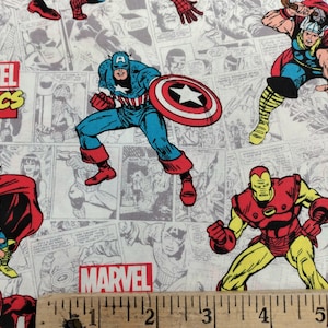 May include: A white fabric with a repeating pattern of comic book characters, including Captain America, Iron Man, and Thor. The fabric features the word "MARVEL" in red letters and a ruler for scale.