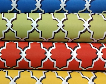 May include: Four fabric rolls with a geometric pattern. The rolls are stacked on top of each other. The top roll is blue, the second roll is green, the third roll is red, and the bottom roll is yellow.