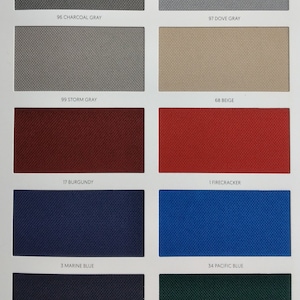 May include: A colour chart with fabric swatches in various colours, including charcoal grey, dove grey, storm grey, beige, burgundy, firecracker, marine blue, pacific blue, navy, and forest green. Each swatch is labelled with a number and the colour name.