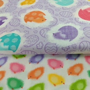 May include: Two pieces of fabric with an Easter theme. The top fabric is purple with a white background and features chicks hatching from eggs. The bottom fabric is white with a variety of colored chicks.