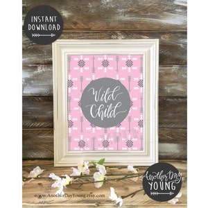 Puede incluir: Una impresión de arte de guardería imprimible con un patrón geométrico rosa y gris y el texto "Wild Child" en un círculo gris.