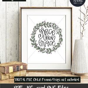 May include: A printable digital download of a hand-lettered quote, "grace upon grace", surrounded by a wreath of green leaves and pink berries. The quote is in black ink and the background is white.