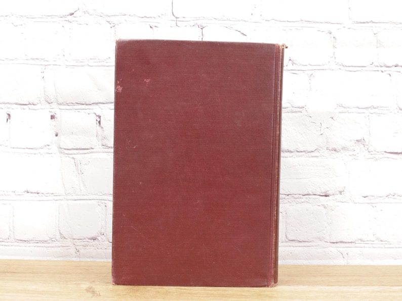 Pu&ograve; includere: Un libro rilegato in tela color bordeaux con una copertina liscia.