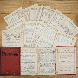 May include: A collection of vintage paper ephemera from the Wanamaker department store in Philadelphia, Pennsylvania. The papers include advertisements for hats, millinery, ribbons, silks, velvets, and laces, as well as a page from a 1912 diary. The text on the papers includes the phrase "The Wanamaker Stores in America" and "Ge-Ge" perfume.